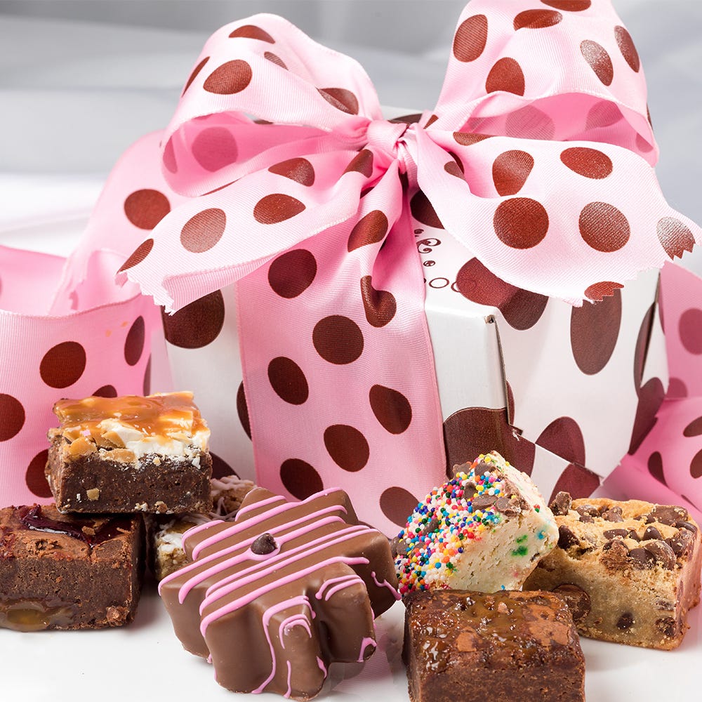 Box of 1 chocolate covered flower shaped brownie and 6 assorted brownie bites in box with pink polka dot ribbon