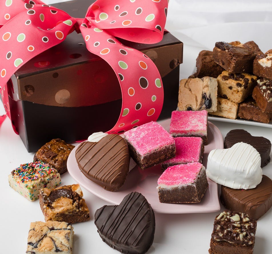 Brown box with Pink dotted ribbon including variety of 24 baby brownies and 6 ganache covered brownie hearts 