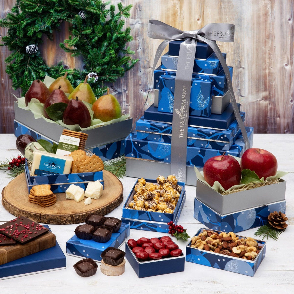 5 blue with silver trim and blue pear holiday themed boxes filled with fruit and treats and silver ribbon